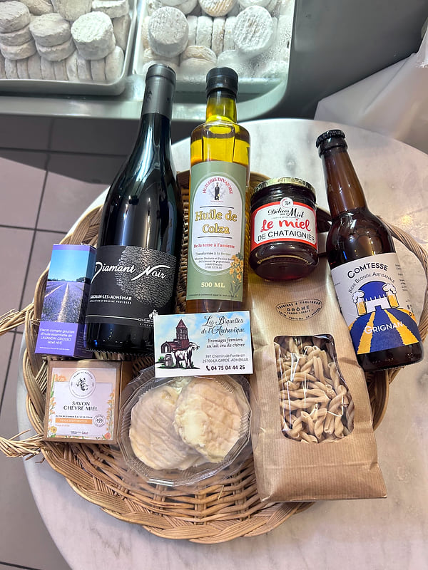 Un panier garni de vin, d'huile, de miel, de bière et de fromages de la ferme